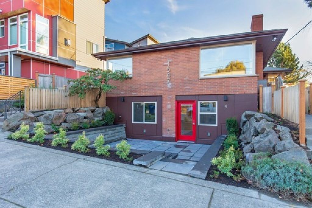 1547 NW 63rd St Apartment exterior brick building two story with front landscaping and red door