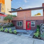 1547 NW 63rd St Apartment exterior brick building two story with front landscaping and red door