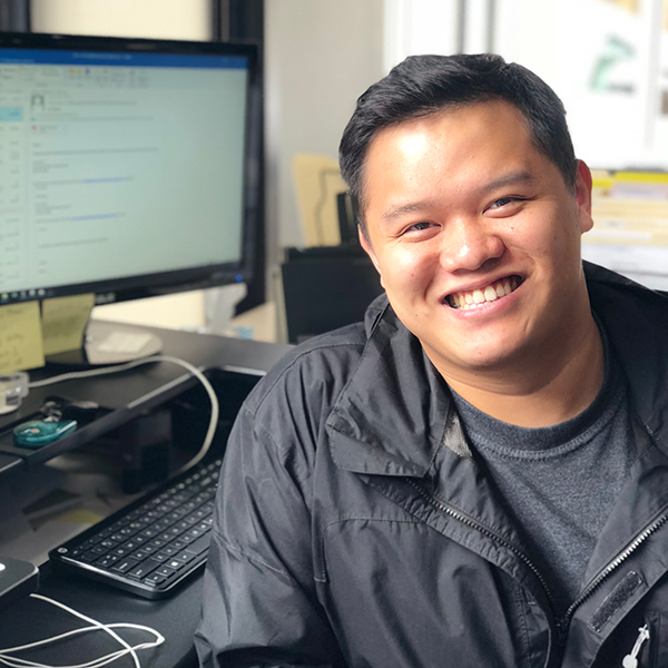 Danny Thai Accounts Payable square headshot sitting at desk