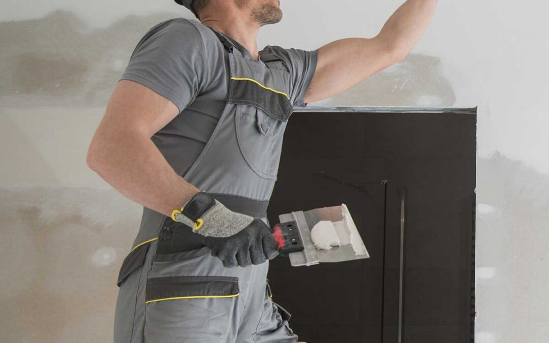 Stock photo of a man applying drywall