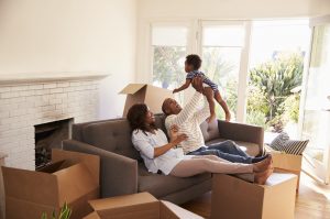 Parents holding their baby while unpacking